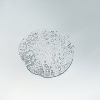 Woman using AccuFix AHA/BHA Body Wash — deep cleansing formula with lactic acid and salicylic acid for smoother, acne-free skin.